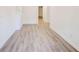 Hallway with new light wood-look flooring, neutral walls, and white trim throughout at 809 Vinton Wood Rd, Forest Park, GA 30297
