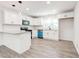 Modern kitchen with white cabinetry, granite countertops, stainless steel appliances and wood-look flooring at 809 Vinton Wood Rd, Forest Park, GA 30297