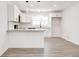This bright, open-concept kitchen features white cabinets, gray countertops, and modern light fixtures at 809 Vinton Wood Rd, Forest Park, GA 30297