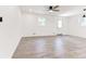 Spacious, bright living room with sleek light-colored floors and modern lighting at 809 Vinton Wood Rd, Forest Park, GA 30297