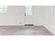 Clean, bright living room with modern gray floors and a back door at 809 Vinton Wood Rd, Forest Park, GA 30297