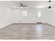 Modern living room with light-colored floors, ceiling fan, and a back door at 809 Vinton Wood Rd, Forest Park, GA 30297