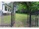 Gated backyard entrance leading to an expansive lawn and serene wooded area at 823 Laurel Crest Sw Ct, Marietta, GA 30064