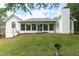 Large backyard with a screened-in porch, mature trees, and lush greenery at 823 Laurel Crest Sw Ct, Marietta, GA 30064