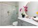 Elegant bathroom featuring white marble shower with glass door and brass fixtures at 823 Laurel Crest Sw Ct, Marietta, GA 30064