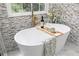 Serene bathroom featuring a freestanding tub, mosaic tile, and luxurious gold hardware at 823 Laurel Crest Sw Ct, Marietta, GA 30064