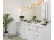 Bright bathroom featuring a long vanity with double sinks, white cabinetry, and modern light fixture at 823 Laurel Crest Sw Ct, Marietta, GA 30064