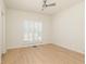 Simple bedroom featuring neutral walls, wood flooring, and bright window with plantation shutters at 823 Laurel Crest Sw Ct, Marietta, GA 30064