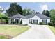 Charming single-story home featuring a beautifully maintained lawn and long driveway at 823 Laurel Crest Sw Ct, Marietta, GA 30064