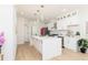 Bright open kitchen featuring white cabinetry, stone countertops, and oversized kitchen island at 823 Laurel Crest Sw Ct, Marietta, GA 30064