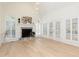 Sunlit living room featuring a marble fireplace, shuttered windows, and hardwood flooring at 823 Laurel Crest Sw Ct, Marietta, GA 30064