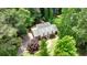 An aerial view of a charming brick home nestled among lush trees with a manicured front lawn at 95 Brandon Ridge Dr, Atlanta, GA 30328