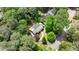 Aerial view of a beautiful home nestled among lush trees, featuring manicured landscaping and a curved walkway at 95 Brandon Ridge Dr, Atlanta, GA 30328