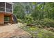 Charming backyard with brick patio, stone pathway, and garden area, creating a serene outdoor space at 95 Brandon Ridge Dr, Atlanta, GA 30328