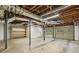 Unfinished basement with exposed pipes, garage door, and storage shelves at 95 Brandon Ridge Dr, Atlanta, GA 30328