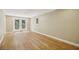 Finished basement featuring wood-look flooring, double glass doors, and neutral paint at 95 Brandon Ridge Dr, Atlanta, GA 30328