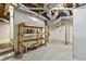Unfinished basement with exposed pipes and shelving for storage, offering potential for customization at 95 Brandon Ridge Dr, Atlanta, GA 30328