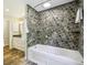 Modern bathroom features a large soaking tub, mosaic tile walls, and a separate vanity area, perfect for relaxation at 95 Brandon Ridge Dr, Atlanta, GA 30328