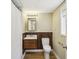 Bathroom with single vanity featuring modern fixtures, wood paneling, and neutral walls at 95 Brandon Ridge Dr, Atlanta, GA 30328