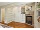 Bedroom featuring custom built-in shelving, closet space, and a cozy fireplace, adding character and functionality to the room at 95 Brandon Ridge Dr, Atlanta, GA 30328