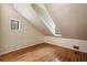 Bedroom with hardwood floors, slanted ceilings, two small windows, and neutral paint at 95 Brandon Ridge Dr, Atlanta, GA 30328