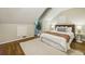 Bedroom with slanted ceilings, hardwood floors, neutral colors, and large area rug at 95 Brandon Ridge Dr, Atlanta, GA 30328
