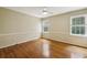 Bright bedroom with hardwood floors, neutral walls, ceiling fan and two large windows at 95 Brandon Ridge Dr, Atlanta, GA 30328