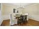 Formal dining room with modern chandelier, neutral walls, hardwood floors, and seating for six at 95 Brandon Ridge Dr, Atlanta, GA 30328