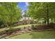 Brick home with dormers, beautiful landscaping, and a curved brick walkway leading to the front door at 95 Brandon Ridge Dr, Atlanta, GA 30328