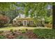 Charming brick home featuring manicured landscaping, dormer windows, and a welcoming walkway to the front door at 95 Brandon Ridge Dr, Atlanta, GA 30328