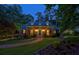 Charming brick home with dormers and manicured front lawn illuminated at dusk at 95 Brandon Ridge Dr, Atlanta, GA 30328