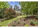 Charming brick home with dormers, beautiful landscaping, and a curved brick walkway leading to the front door at 95 Brandon Ridge Dr, Atlanta, GA 30328