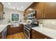 Updated kitchen featuring stainless steel appliances, quartz countertops, mosaic backsplash, and custom lighting at 95 Brandon Ridge Dr, Atlanta, GA 30328