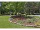 Beautifully landscaped yard with stone borders, trees, flowering plants, and mulch at 95 Brandon Ridge Dr, Atlanta, GA 30328