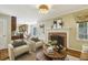 Cozy living room with brick fireplace, stylish furniture, hardwood floors, and large windows allowing natural light at 95 Brandon Ridge Dr, Atlanta, GA 30328
