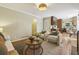 Open-concept living room with access to the kitchen, hardwood floors, stylish furniture, and neutral decor at 95 Brandon Ridge Dr, Atlanta, GA 30328
