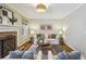 Inviting living room featuring a brick fireplace, hardwood floors, comfortable seating, and ample natural light at 95 Brandon Ridge Dr, Atlanta, GA 30328