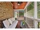 Relaxing screened porch featuring a comfortable couch, wood ceiling, and ceiling fan for added comfort at 95 Brandon Ridge Dr, Atlanta, GA 30328