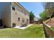 Spacious backyard with a patio, seating, lush lawn, and meticulously maintained retaining wall for outdoor enjoyment at 1749 Grand Oaks Dr, Woodstock, GA 30188