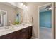 This bathroom features a double sink vanity and a view into the adjacent bedroom at 1749 Grand Oaks Dr, Woodstock, GA 30188