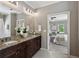 Elegant bathroom featuring granite countertop with double sink and a doorway to main bedroom at 1749 Grand Oaks Dr, Woodstock, GA 30188