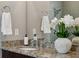 Close-up on the granite countertop with sink, and decor in naturally-lit bathroom with neutral walls at 1749 Grand Oaks Dr, Woodstock, GA 30188