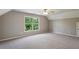 This bedroom features a window letting in natural light and neutral carpeting at 1749 Grand Oaks Dr, Woodstock, GA 30188