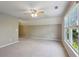 This bonus room features a window letting in natural light and neutral carpeting at 1749 Grand Oaks Dr, Woodstock, GA 30188