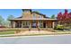 Charming clubhouse exterior featuring a welcoming porch, stone accents, and attractive landscaping at 1749 Grand Oaks Dr, Woodstock, GA 30188