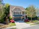 Charming two-story home with a front porch, a two-car garage, and well-manicured landscaping at 1749 Grand Oaks Dr, Woodstock, GA 30188