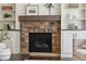 Living room fireplace features stone surround, wood mantle, and built-in bookshelves at 1749 Grand Oaks Dr, Woodstock, GA 30188