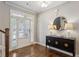 Welcoming foyer with hardwood floors, console table, decorative lamps and staircase at 1749 Grand Oaks Dr, Woodstock, GA 30188