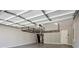 Clean garage with a pristine epoxy floor, overhead storage racks, and a water heater offering functional space at 1749 Grand Oaks Dr, Woodstock, GA 30188