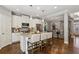 Well-lit kitchen featuring white cabinets, stainless steel appliances, and a granite island at 1749 Grand Oaks Dr, Woodstock, GA 30188